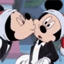 Mickey Mouse And Minnie Mouse Kissing Each Other In A Cartoon . GIF