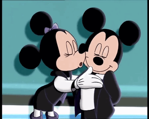 Mickey Mouse And Minnie Mouse Kissing Each Other In A Cartoon GIF