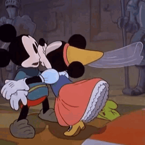 Mickey Mouse And Minnie Mouse Kissing In A Cartoon . GIF