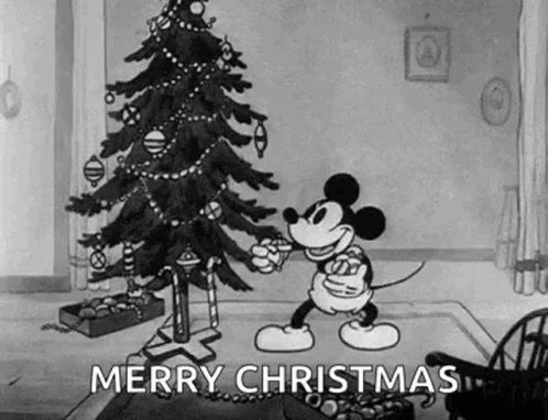 Mickey Mouse Is Decorating A Christmas Tree In A Living Room . GIF