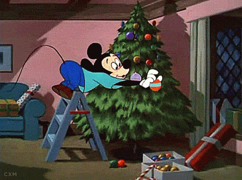 Mickey Mouse Is Decorating A Christmas Tree In A Room GIF