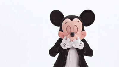 Mickey Mouse Is Wearing A Black Jacket And Red Shorts GIF