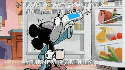 Mickey Mouse Sitting in Front of Open Refrigerator Holding Cell Phone