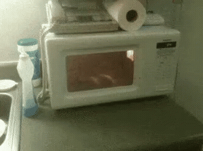 Microwave Oven Next To Soap And Paper Towels GIF