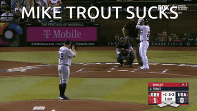 Mike Trout Sucks On A Baseball Field With A T Mobile Ad In The Background GIF