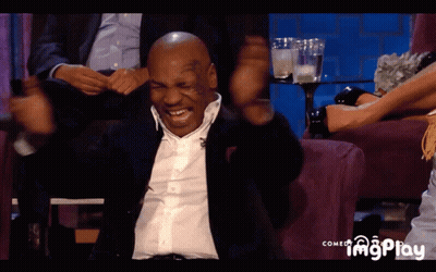 Mike Tyson Is Sitting On A Couch With His Arms Up GIF