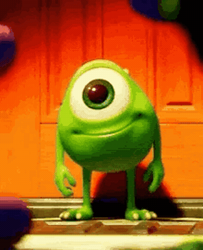 Mike Wazowski From Monsters Inc Is Standing In Front Of A Door . GIF