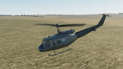 Military Helicopter Flying Over Grassy Field GIF