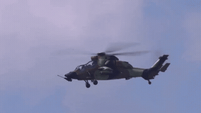 Military Helicopter Flying Through Blue Sky