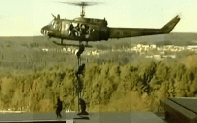 Military Helicopter With Soldiers Hanging From Side GIF