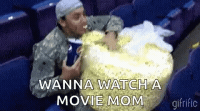 Military Man Eating Popcorn And Drinking Soda In Theater GIF