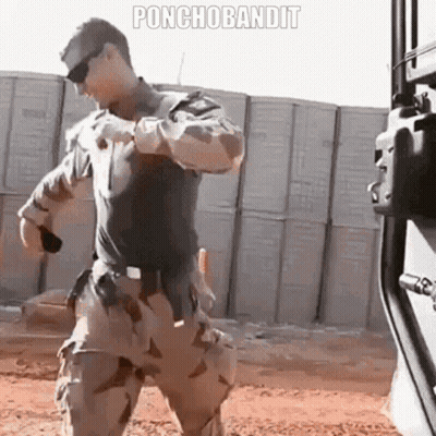Military Man Standing Before Ponchobandit Wall GIF