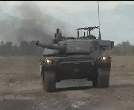 Military Tank Driving Down Dirt Road GIF