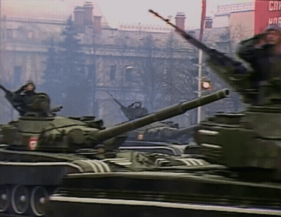 Military Tanks Driving Past Red CNN Building GIF