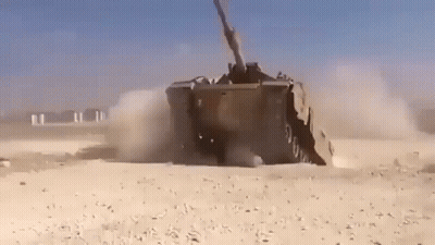 Military Vehicle Driving Through Desert GIF