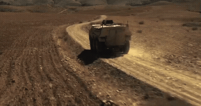 Military Vehicle On Desert Dirt Road GIF