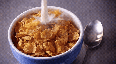 Milk Is Being Poured Into A Bowl Of Corn Flakes GIF