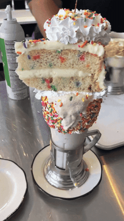 Milkshake With Cake Slice And Sprinkles GIF