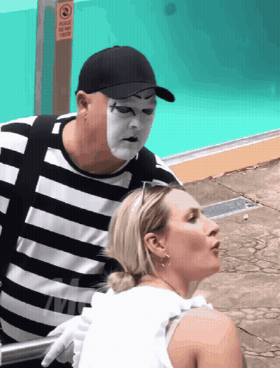 Mime Masked Man Next To Woman By Pool GIF