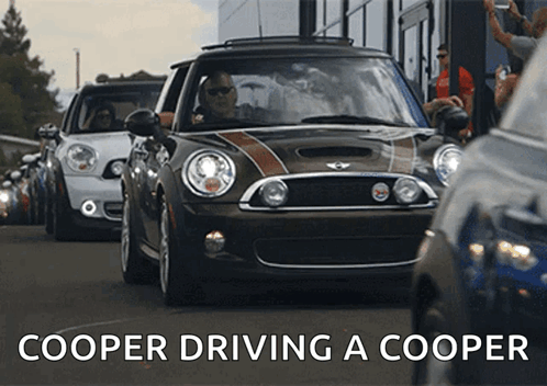 Mini Cooper Cars Driving Down A Road GIF