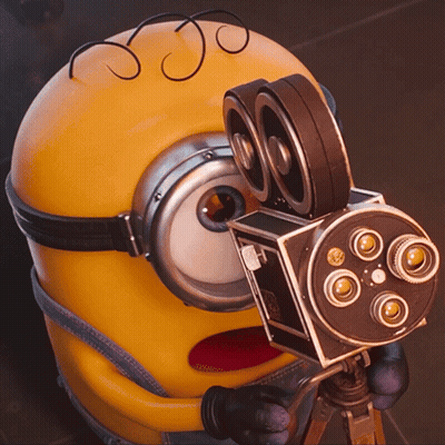 Minion Holding Camera With Number 80 GIF