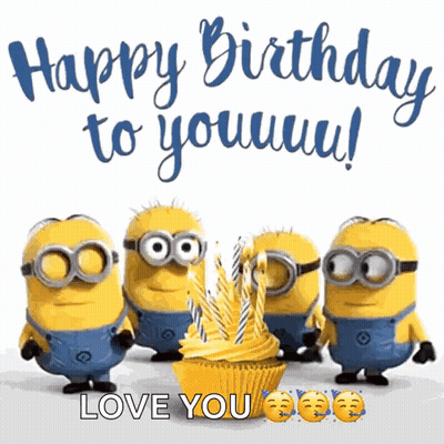 Minions Standing Around Cupcake With Candles GIF