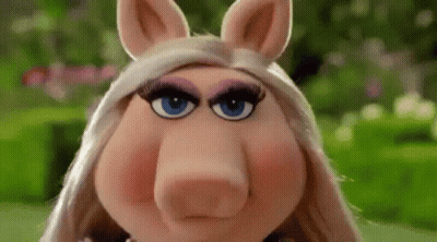 Miss Piggy From The Muppet Show Is Making A Funny Face With Her Eyes Closed . GIF