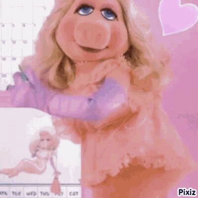 Miss Piggy From The Muppets Is Wearing A Pink Dress And Gloves And Is Standing In Front Of A Calendar . GIF