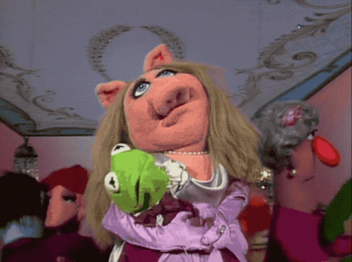 Miss Piggy Is Holding A Green Kermit The Frog In Her Arms GIF