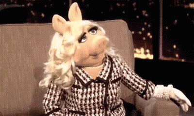 Miss Piggy Sitting With Outstretched Arm GIF