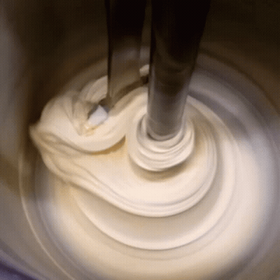 Mixer Mixing White Substance In Container GIF
