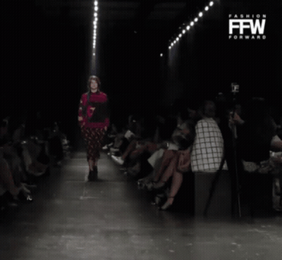 Model Walking Down Runway at Fashion Event