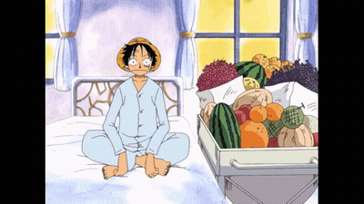 Monkey D Luffy Sitting On Bed Next To Box Of Fruit GIF