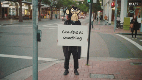 Monkey Holding Sign Saying Can Devs Do Something GIF