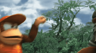 Monkey In Orange Hat Standing In Forest GIF