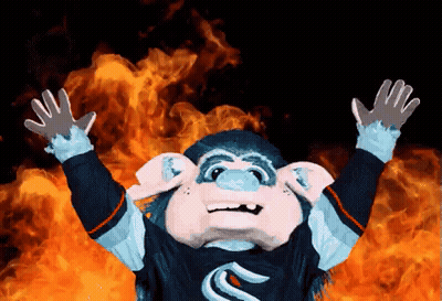 Monkey Mascot Standing In Front Of Fire With Arms Outstretched GIF