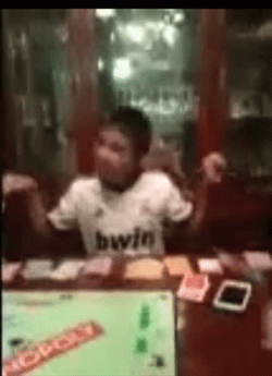 Monopoly Money In Front Of Young Boy GIF
