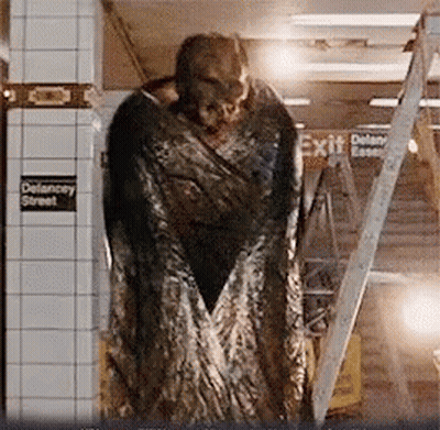 Monster Statue In Front Of Exit Sign GIF