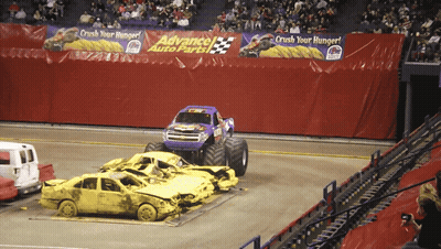 Monster Truck Driving Through Wrecked Cars At Advance Auto Parts GIF