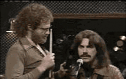 More Cowbell Playing Cowbells And Singing GIF