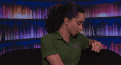 Morgan Veto Holder Holding Glass By Bookshelf GIF