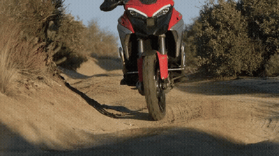 Motorcycle Driving Down Dirt Road Saying Motorcycle GIF