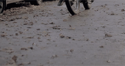 Motorcycle Driving Down Road With Car Behind GIF