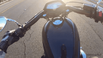 Motorcycle Driving Down Road With Motorcyclist Text GIF