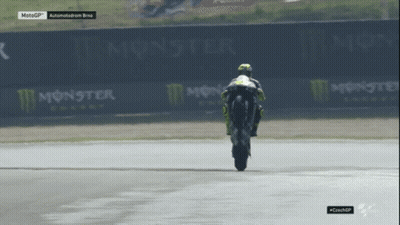 Motorcycle Racer Doing Trick On Track With Monster Energy Signs GIF