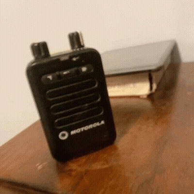 Motorola Walkie Talkie Next To Book GIF