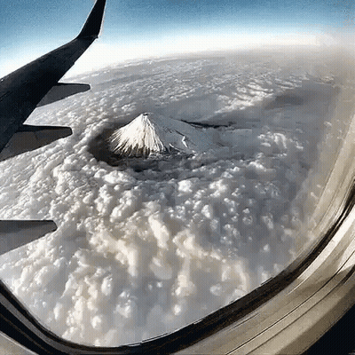 Mountain View From Airplane Window With Clouds GIF
