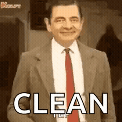 Mr Bean In Suit And Tie Smiling Saying Clean GIF