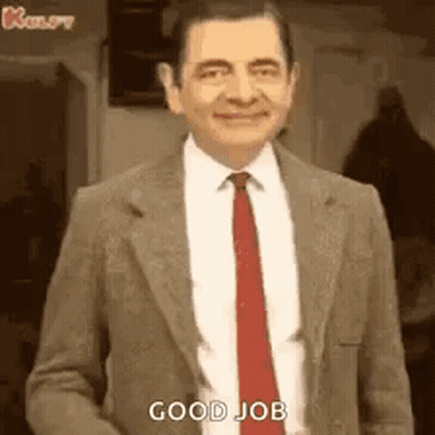 Mr Bean In Suit And Tie Smiling Saying Good Job GIF