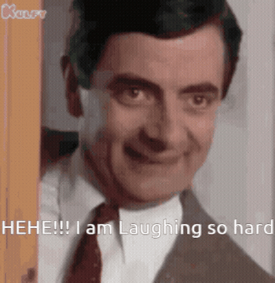 Mr Bean Is Laughing So Hard While Peeking Out Of A Doorway . GIF